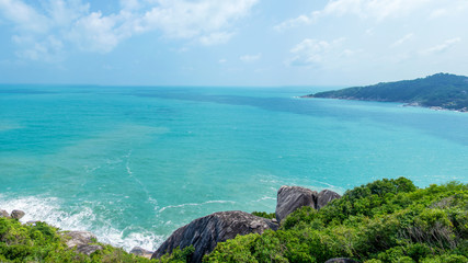 Rocky rock over beautiful clear sea and island, view from Kho Phangan, Thailand