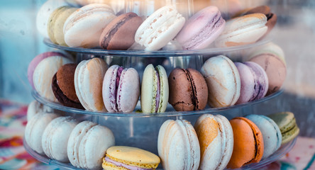 French macrons cookies with sprinkles yellow pink blue white red on the platter