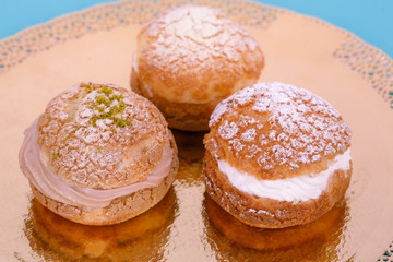 Custard cakes with cream on a blue background