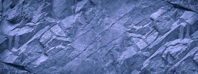 Blue white grunge background. Light blue stone background. Toned mountain texture close-up. Banner with copy space for your design. Decorative volumetric rock background.