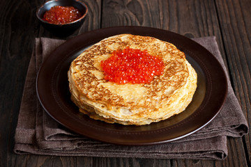 Traditional russian pancakes blini with red caviar