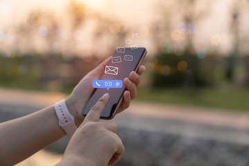 Contact us or Customer support hotline people connect. Businessman using a mobile phone with the (email, call phone, mail) icons.