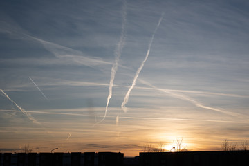 Naklejka na ściany i meble air pollution from aircraft. lines in the air. sunset in the background. Zeewolde flevoland the netherlands 2020
