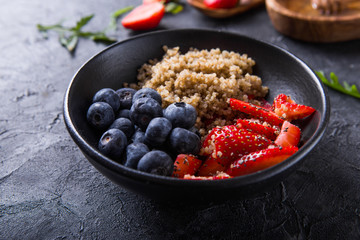 Healthy vegan diet salad quinoa with blueberry,strawberry, honey and chia seeds. Concept sooper food  eating breakfast. Top view