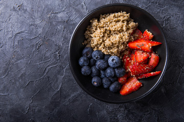 Healthy vegan diet salad quinoa with blueberry,strawberry, honey and chia seeds. Concept sooper food  eating breakfast. Top view