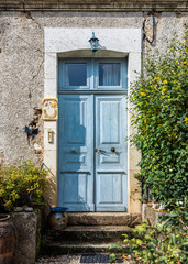 Fototapeta na wymiar Rustic French house with a beautiful blue front door