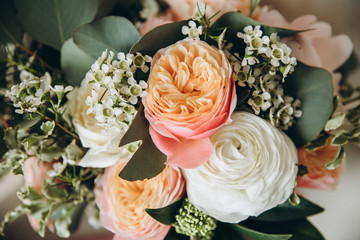 wedding bouquet of pink peonies, white roses and greenery with pink ribbon