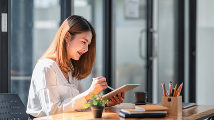 Young businesswoman using tablet in the office