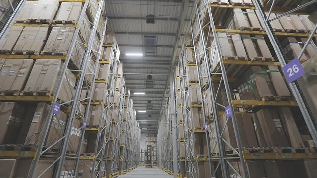 Long rows of bright modern warehouse. Large warehouse with boxes on shelves