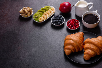 Delicious breakfast with fresh croissants and ripe berries