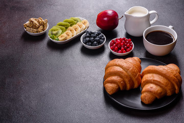 Delicious breakfast with fresh croissants and ripe berries