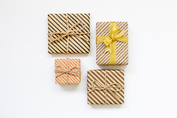 Gift boxes wrapped in striped kraft paper on white background
