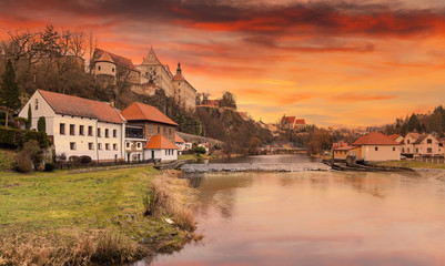 Fototapeta na wymiar Luznice river and medieval castle Bechyne on a sunset. Czech Republic.
