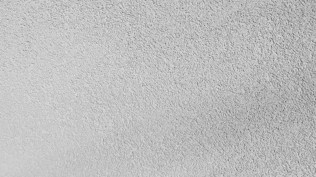 White background texture fast movement of the camera along the wall of plaster and white brick