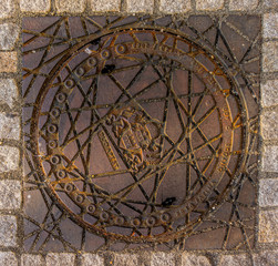 Fototapeta na wymiar Old sewer manhole on a street in Budapest, Hungary 