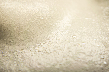 Fototapeta na wymiar Beer foam with pots close-up. Macro photo