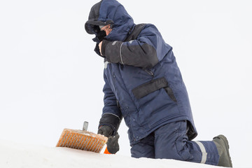 Assembler at the construction site with a brush in his hands