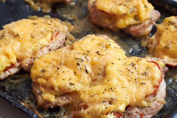 chicken fillet baked in the oven with cheese and tomatoes