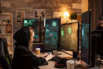 Side view of female hacker writing a dangerous malware