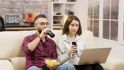 Happy young couple doing online shopping on laptop