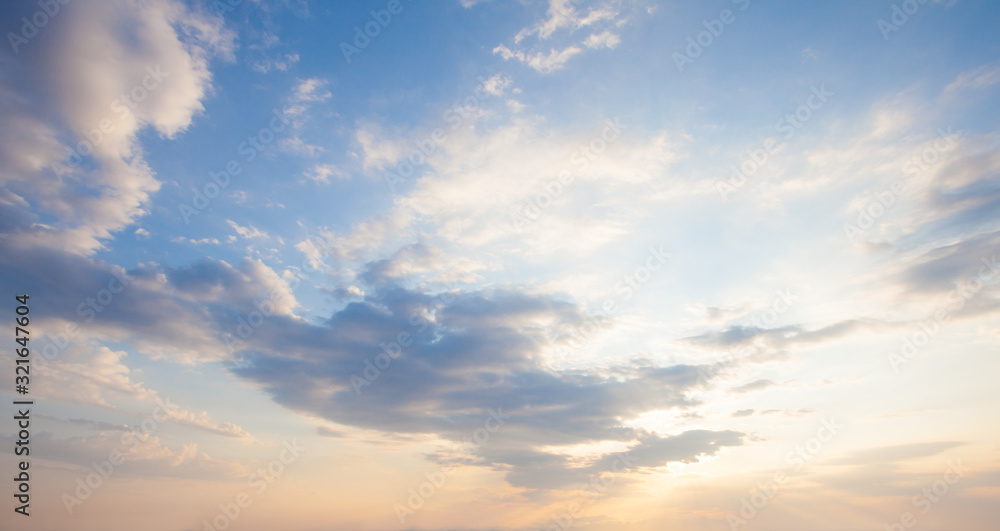 Wall mural blue sky clouds background. beautiful landscape with clouds and orange sun on sky