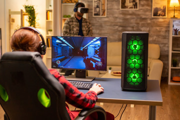 Professional video gamer female playing an online shooter game © DC Studio