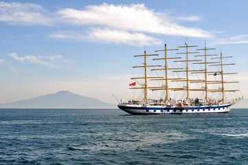 Clipper ship in the sea on mountain range background 