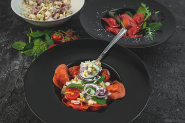 red, tomato-shaped heart-shaped ravioli, with the addition of an Italian salad