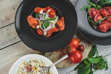 red, tomato-shaped heart-shaped ravioli, with the addition of an Italian salad