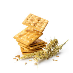 Stack of delicious bran crackers levitate on white background. Bran crackers, rye spikelets and grains isolated on white background.