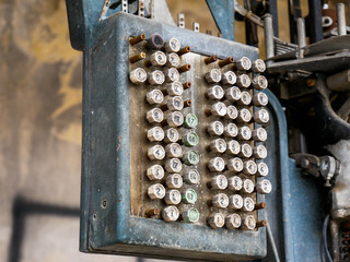 Old industrial scale control panel in abandoned building close up shot.