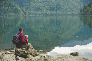 Dad and son walk by the lake