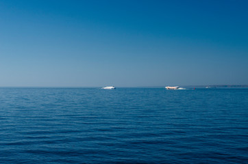 Obraz premium Sea panorama with blue expanse of water and blue sky. Sea skyline with a tall glass skyscraper. The tallest building in Europe. St. Petersburg, Lakhta Center, Russia, May 1, 2019