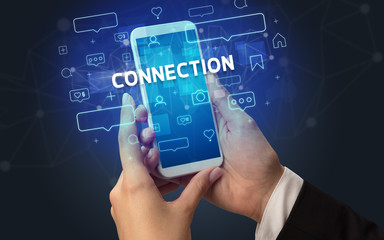 Female hand typing on smartphone with CONNECTION inscription, social media concept