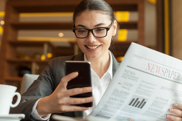 young businesswoman reading newspaper