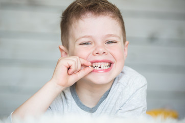 Teenager child with a tooth dropped out