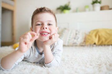 Fototapeta premium Teenager child with a tooth dropped out