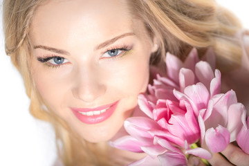 Luxurious blonde with a bouquet of tulips