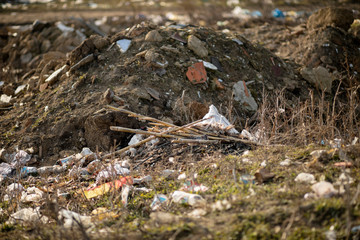A pile of trash abandoned on the grass, littering and polluting the environment