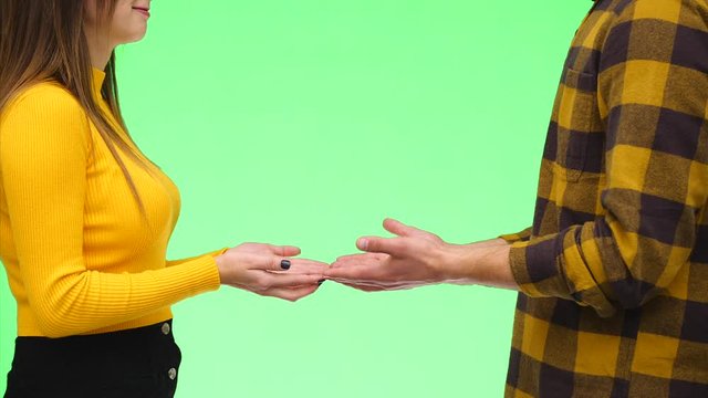 Close yp. Unknown young lovers playfully touch fingers of each other. Copy space. 4K.