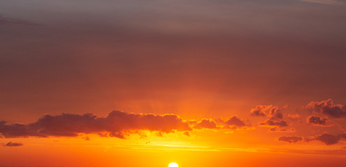 rising sun cloudy sky