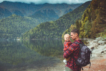 Dad and son walk by the lake