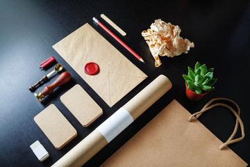 Photo of blank retro stationery set on black wooden background. Corporate identity template.