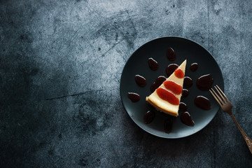 Cheesecake on a plate with strawberry sauce