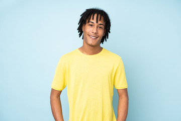 Young african american man isolated on blue background laughing