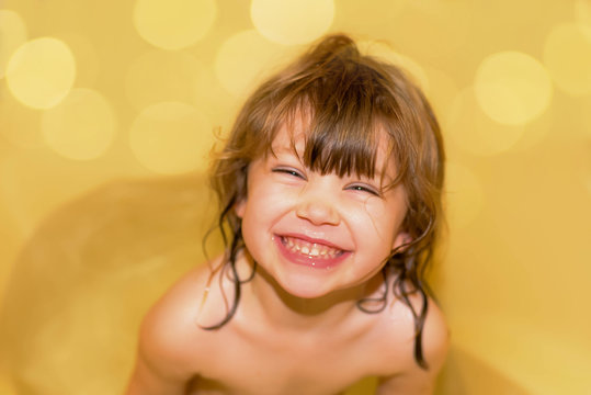 portrait of a pretty little girl in her bath