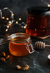 Jar of honey with candles and other romantic elements