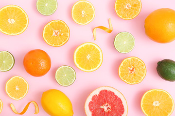 Fototapeta na wymiar Different citrus and juicy slices on a colored background top view. Place to insert text.