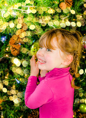 cute little girl in front of christmas decorations