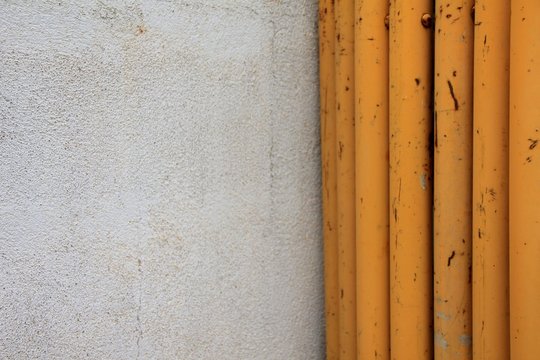 Pared blanca con andamios amarillos.